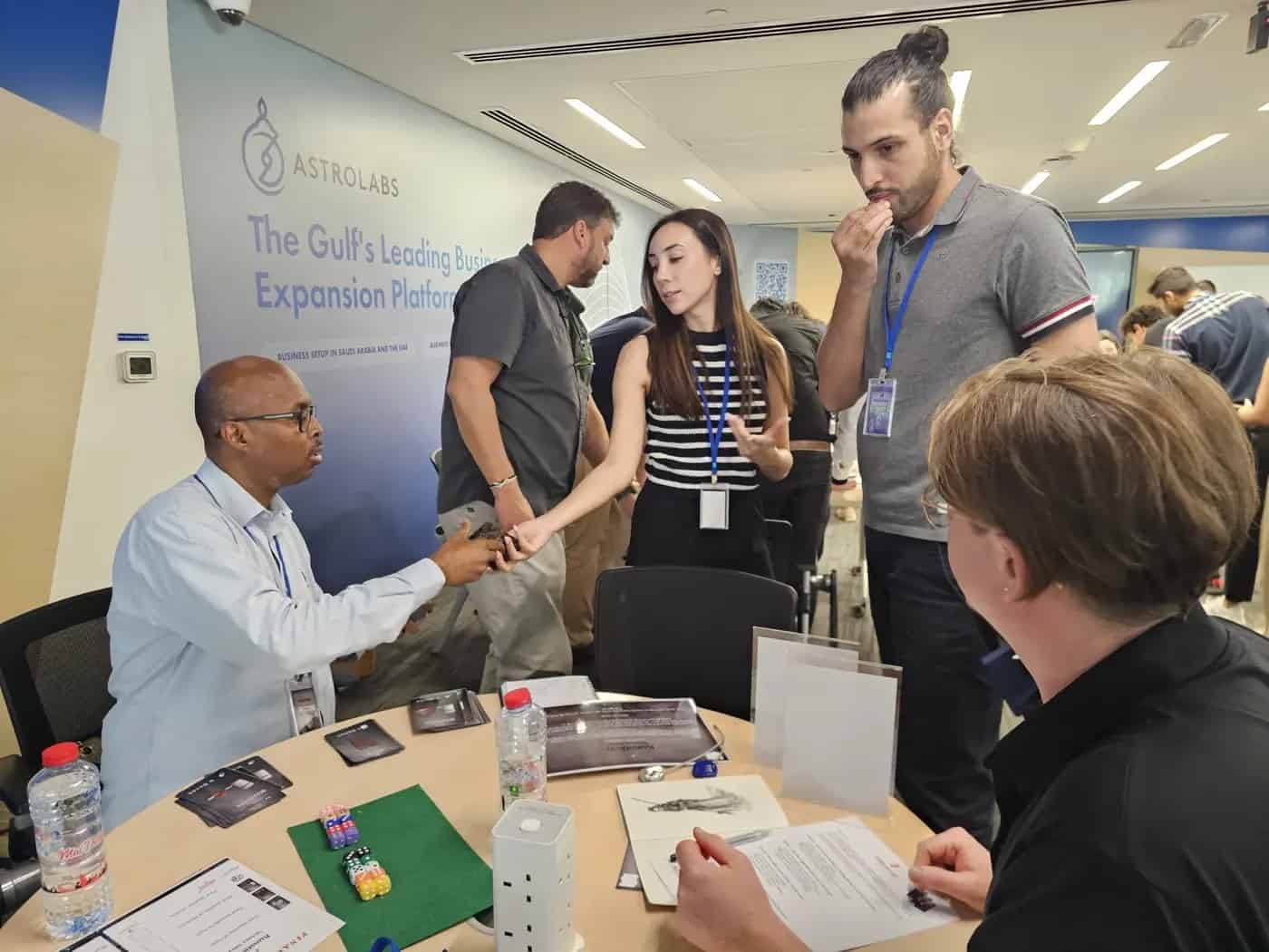 Mounaim Lamouni working with a small business team around a table in Dubai